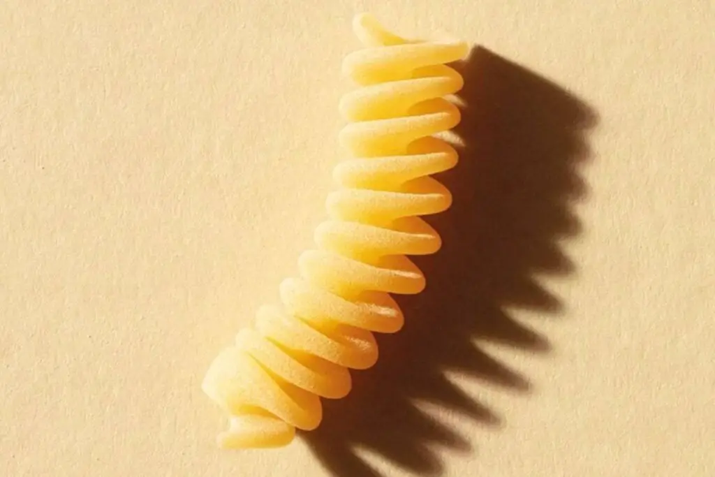 A single fusilli pasta noodle close-up view.