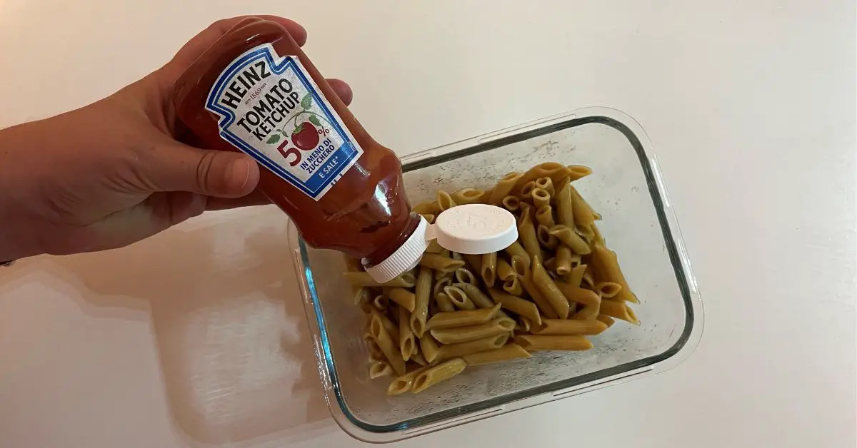 Some pasta that is about to be seasoned with ketchup