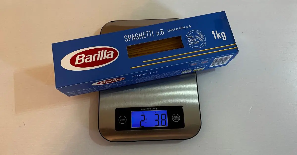 An electronic scale with spaghetti on it.