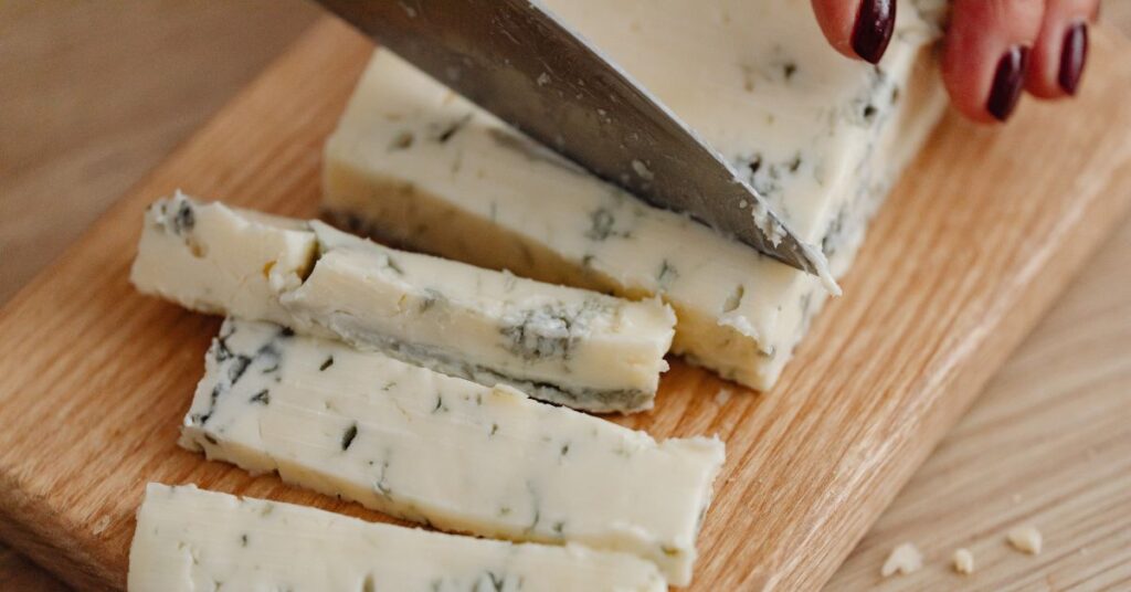 Gorgonzola being cut