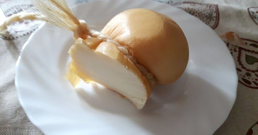 Scamorza cheese spilt in half.