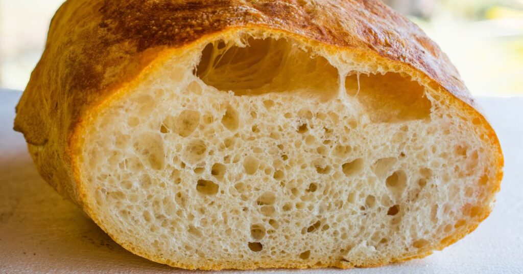 A loaf of Tuscan bread, cut in half.