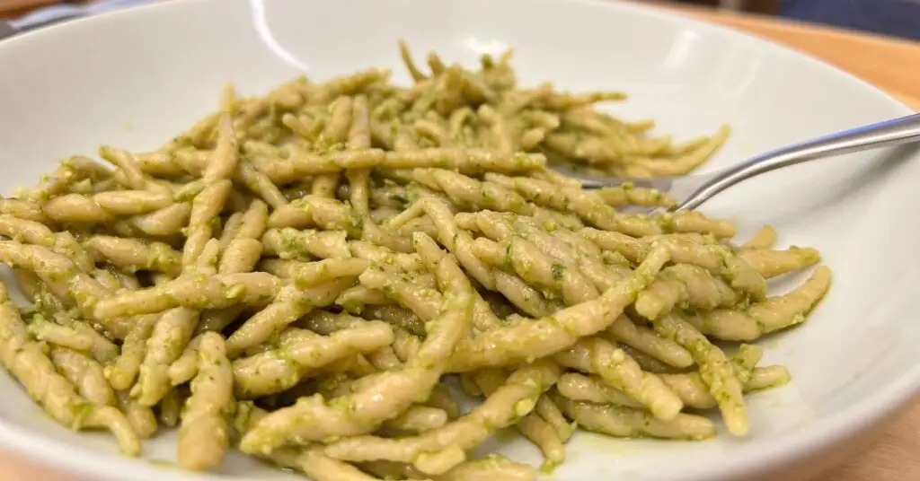 A plate of fresh trofie pasta with pesto sauce, the most classic combination of pesto and pasta.