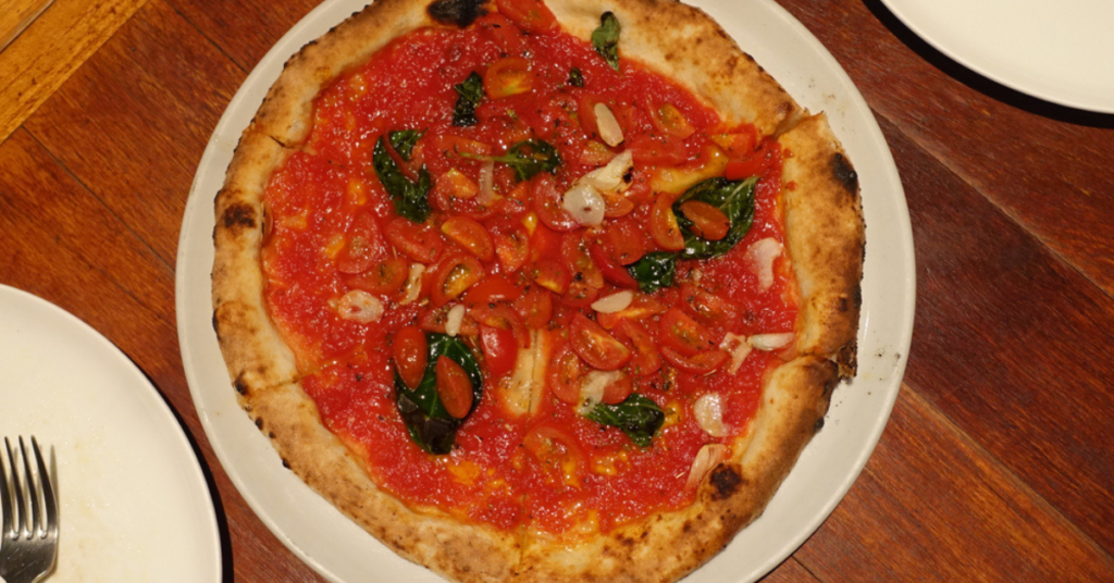 A pizza marinara, that is a tomato based pizza with garlic, basil and oregano but without mozzarella or any other cheese.