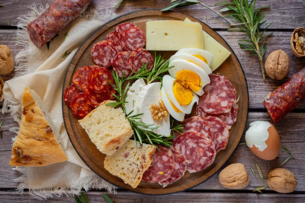 Cold cuts board with salami and different types of cheese and boiled eggs, called Fellata Napoletana.