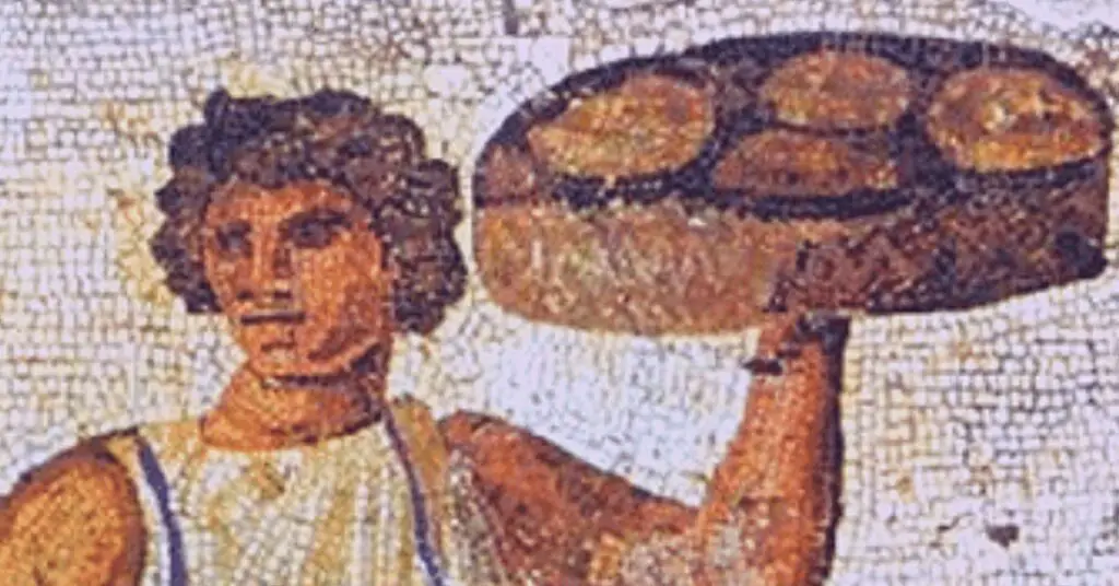 Ancient mosaic depicting a Roman young man carrying stuffed pasta on a tray, they could be the Lagane.