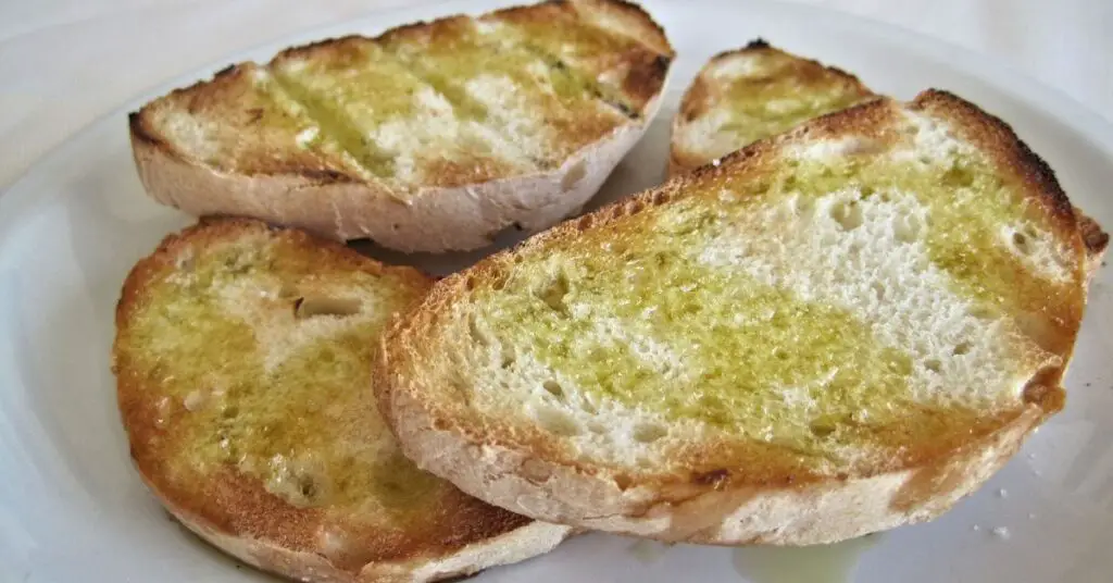 Sliced grilled bread with Extra Virgin Olive Oil.