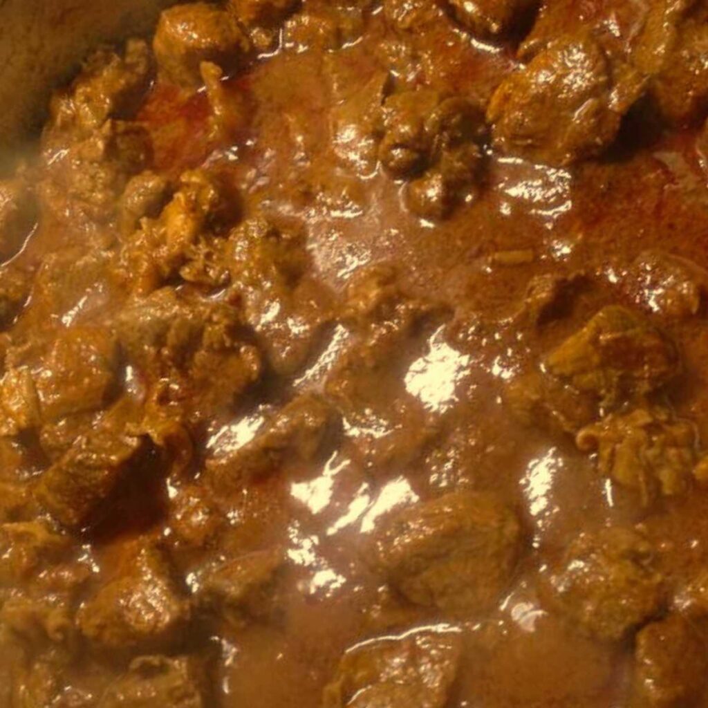 A plate of slow-cooked meat stew with spices, called Sangiovannese Stew in Arezzo.