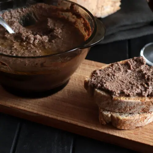 Tuscan chicken liver patè with a brown and creamy appearance, spread on a slice of toasted bread called "crostino".
