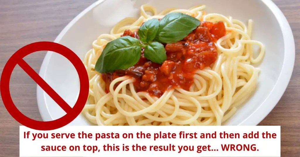 A dish of plain spaghetti with a bit of tomato sauce on top. If you first serve the plain pasta on the plate and then pour a spoonful of sauce over it, you get the classic pasta dish from the movies. It's impossible to mix all the pasta on the plate, so some of it will always remain unseasoned.