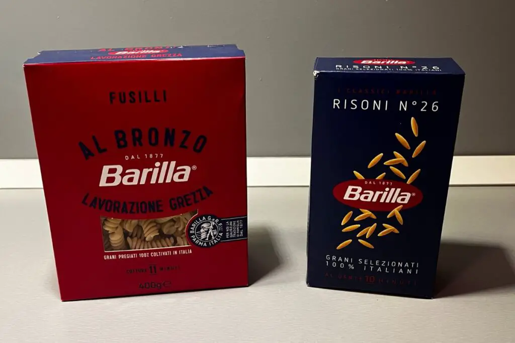 A package of the new Barilla al Bronzo pasta next to a package of the classic Barilla Blue Box.