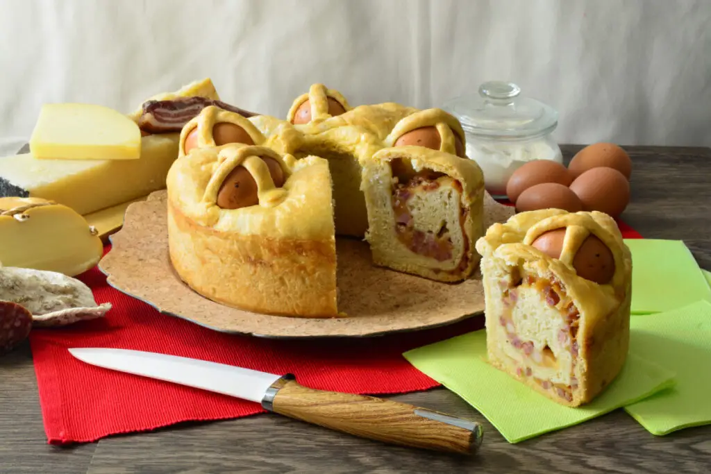 A casatiello Napoletano, a savory pie filled with cheeses and cold cuts, is also recognizable for the hard-boiled eggs with shells embedded inside and protruding from the top of the pie.
