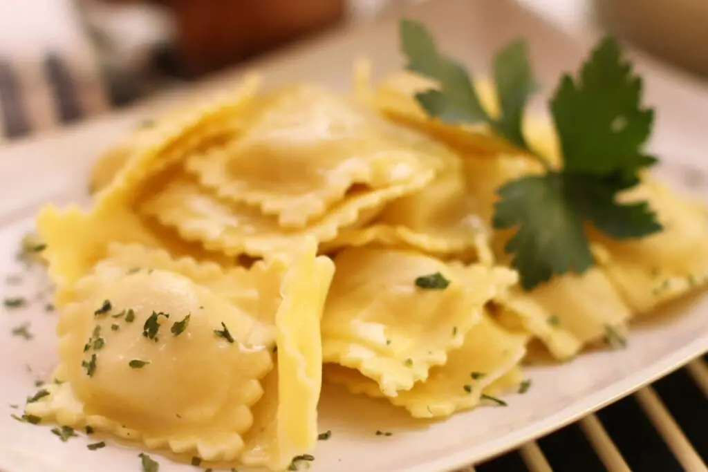 Dish full of potato tortelli, a square-shaped stuffed pasta, they are swollen because they have a mashed potato-based filling inside.