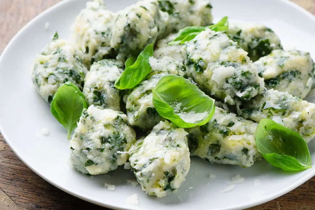 Gnudi gnocchi resemble spinach and ricotta meatballs, in fact they are the internal filling of the ravioli without the dough surrounding them.