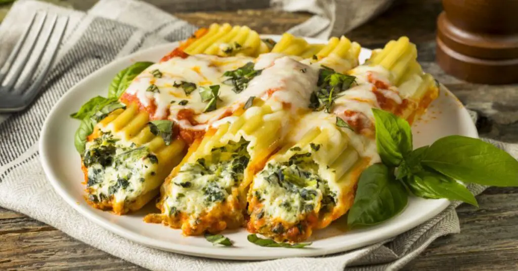 A plate with baked cheese stuffed manicotti