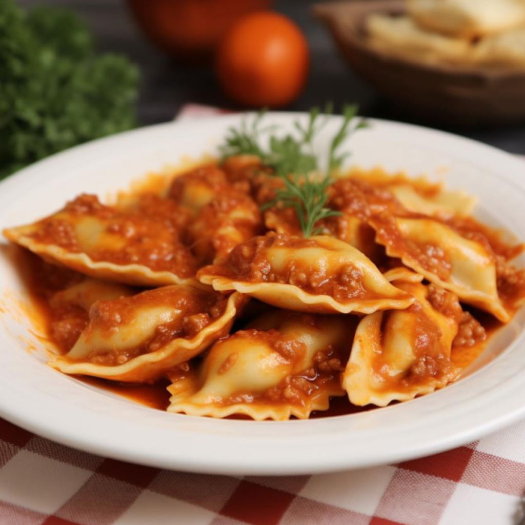 A plate of Todelli Lucchesi, stuffed pasta typical of the Tuscan city of Lucca, crescent-shaped and seasoned with a red meat sauce.