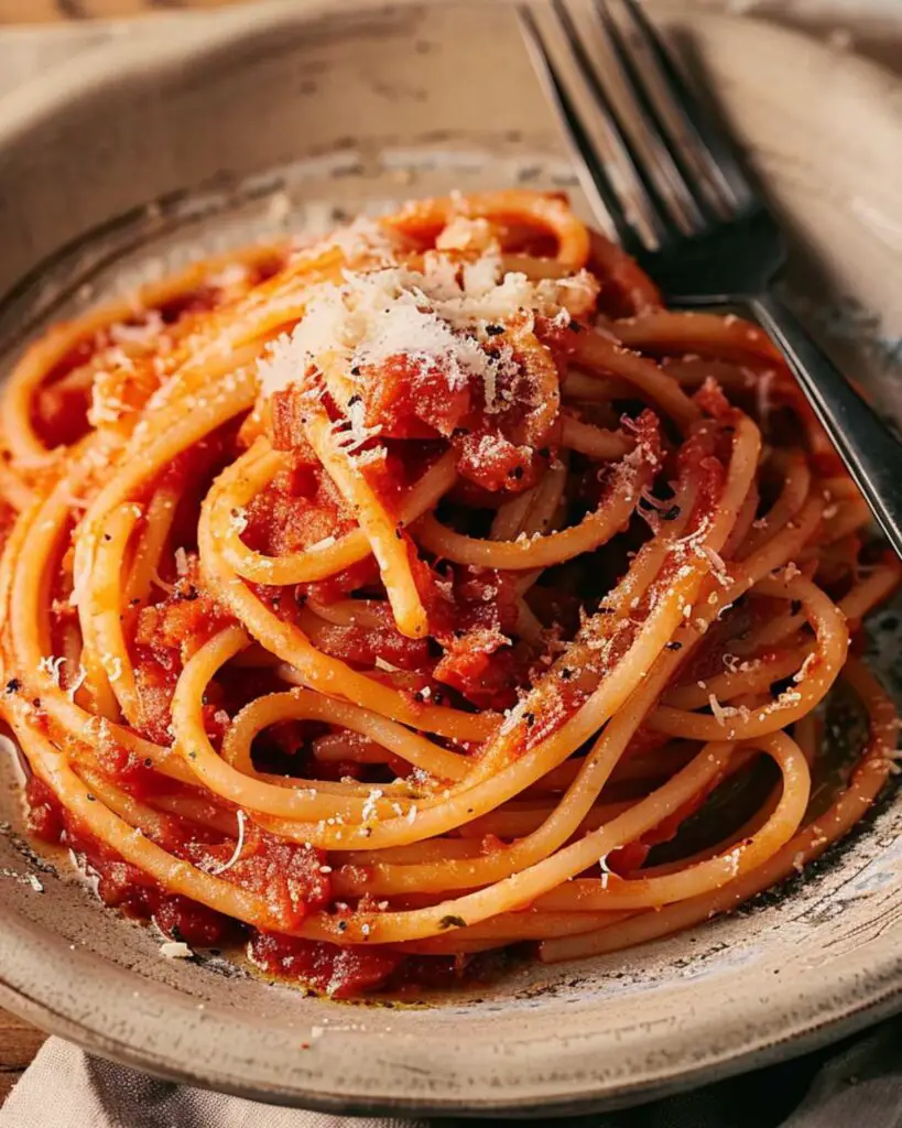 Best authentic Italian pasta recipe featuring Bucatini all’Amatriciana with tomato sauce and pecorino cheese.