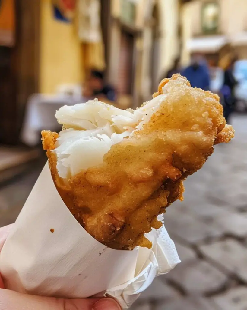 A delicious fried filet of baccalà from Dar Filettaro, showcasing the best street food in Rome.