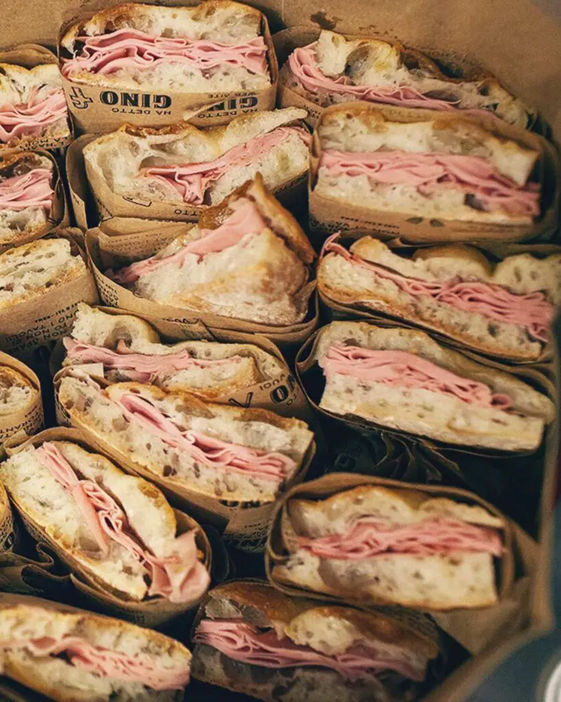  A box of sandwiches filled with mortadella from Gino 1950, showcasing the best street food in Rome.