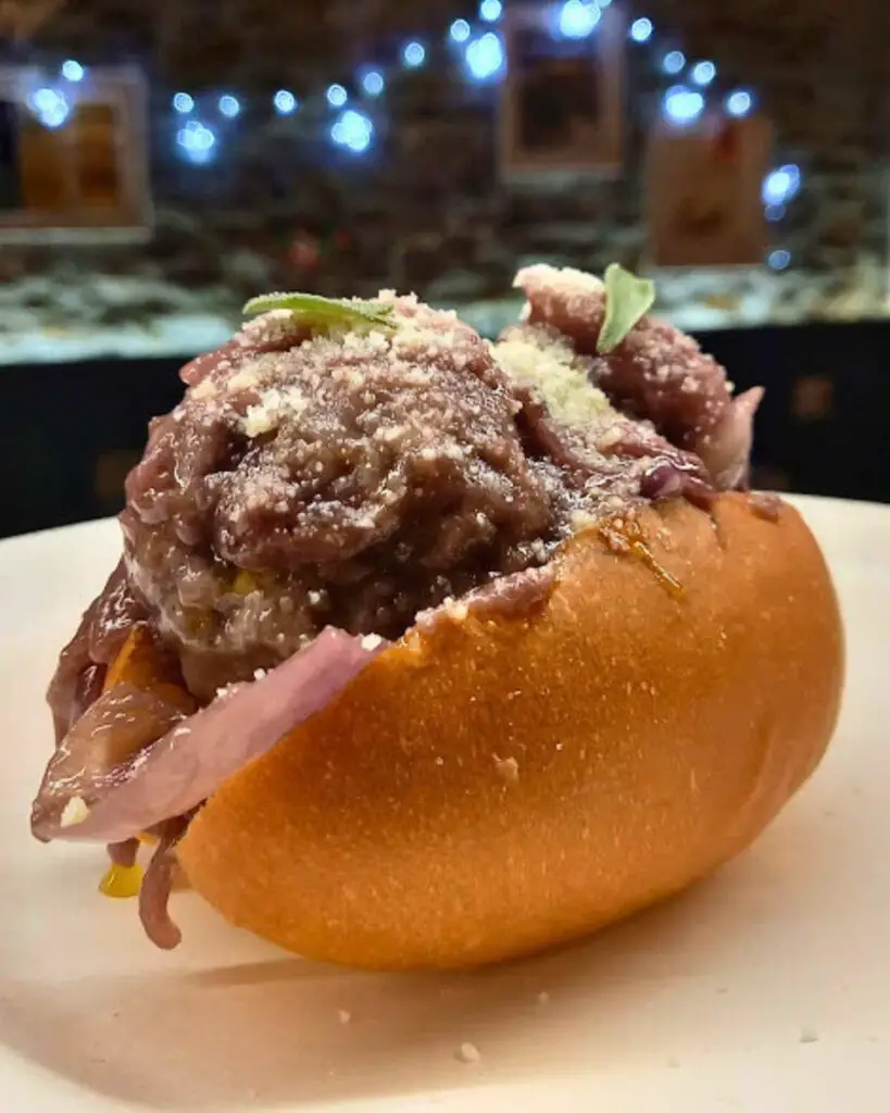 A savory maritozzo filled with meatballs from Il Maritozzo Rosso, showcasing the best street food in Rome.