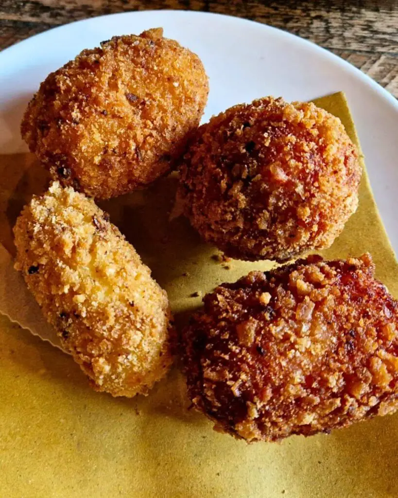 A plate of crispy supplì, a traditional Roman street food, at Supplizio.