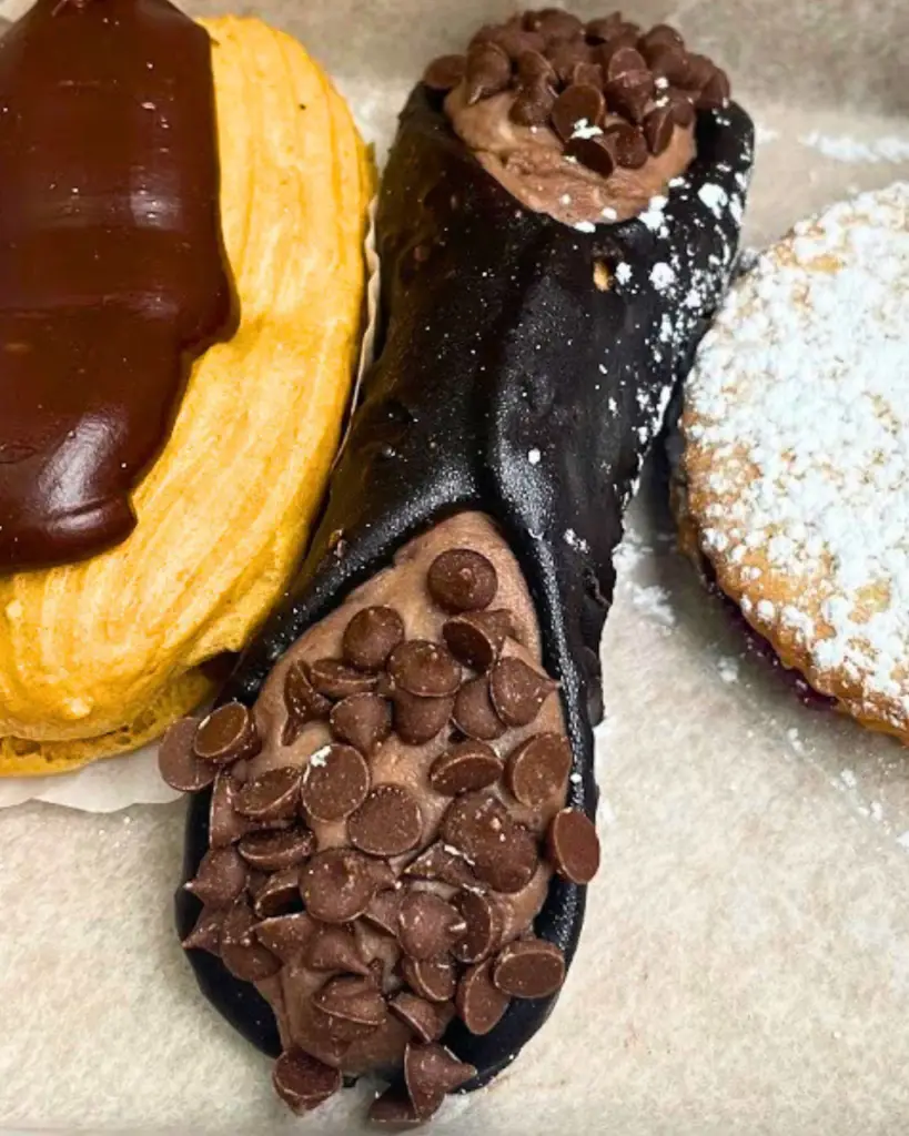 Italian dessert cannoli from Ferrara Bakery & Cafe in Little Italy, showcasing a variety of chocolate and vanilla cannoli.