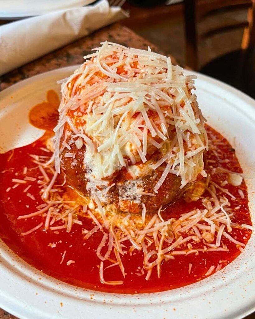 A delicious Italian dish from Ferdinando's Focacceria, topped with rich tomato sauce and grated cheese, showcasing one of the top Italian restaurants in NY.