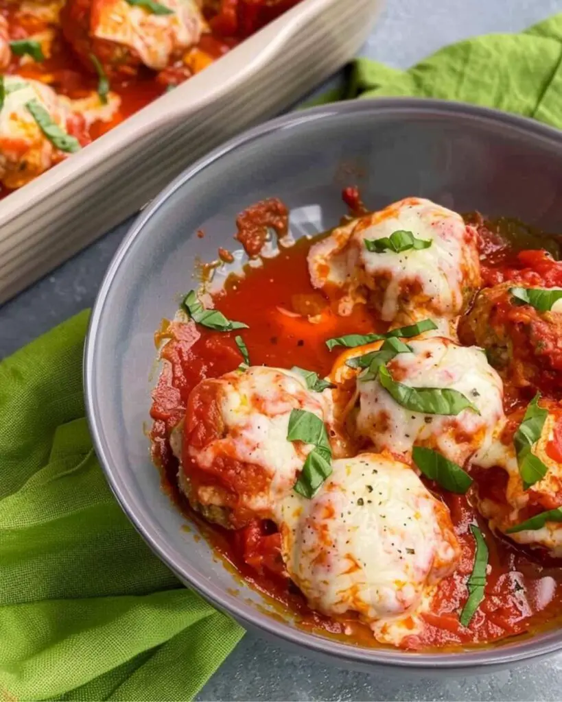 Delicious gluten free chicken meatballs smothered in tomato sauce and melted cheese, a modern twist on an Italian gluten free recipe.