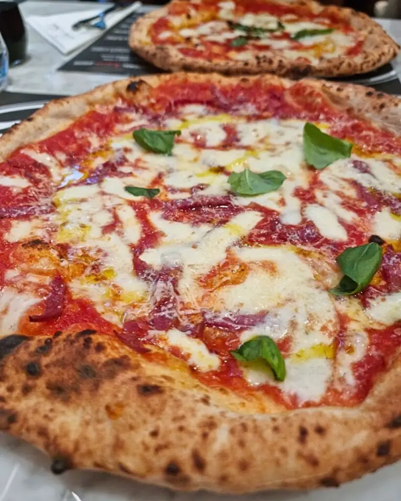 A traditional Neapolitan pizza at 50 Kalò di Ciro Salvo in Rome, perfectly capturing the essence of Naples Pizza in Rome.