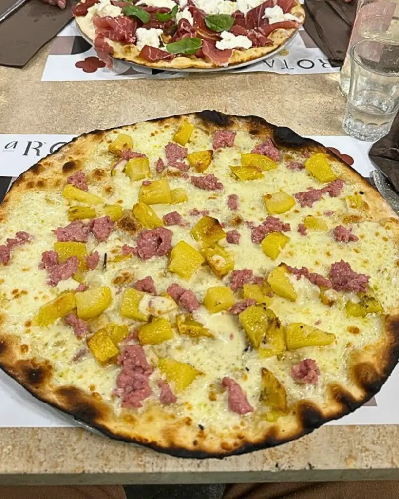 A traditional Roman-style pizza with unique toppings at A Rota Pizzeria Romanesca, a gem among Rome's best pizza places.