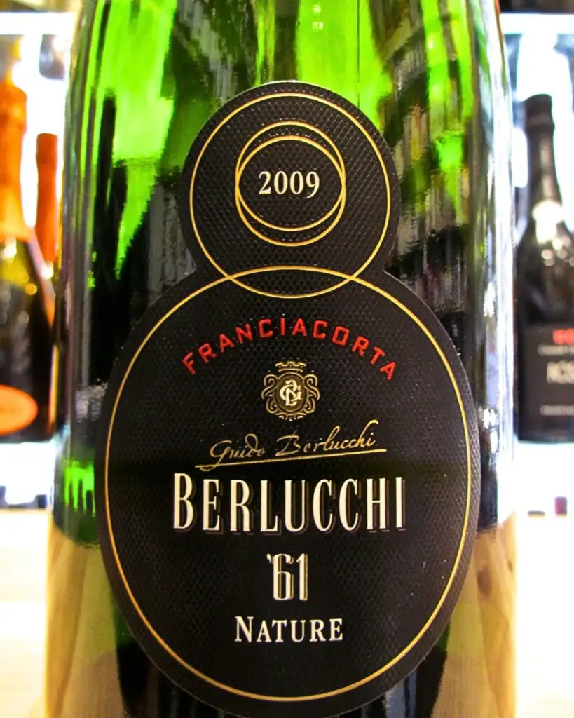 Close-up of a Franciacorta Berlucchi '61 Nature wine bottle, highlighting the elegant Italian wine label and representing one of the best Italian sparkling wines.