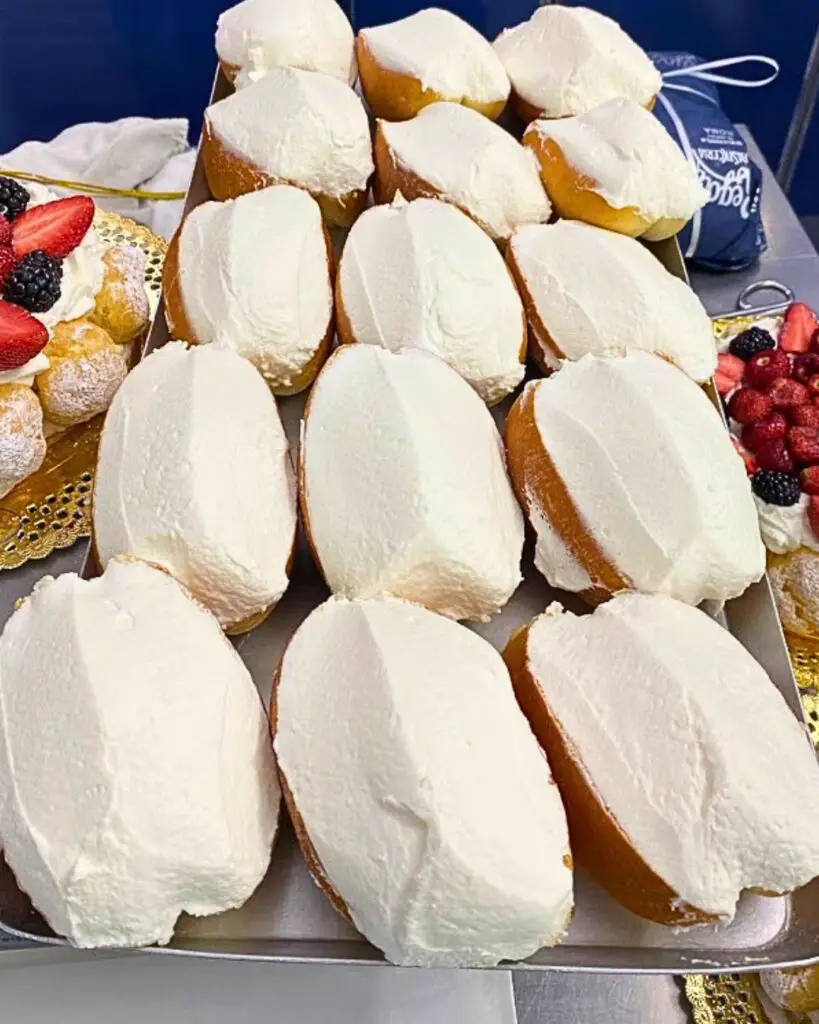 Famous maritozzi from Regoli pastry shop in Rome, topped with fresh whipped cream.