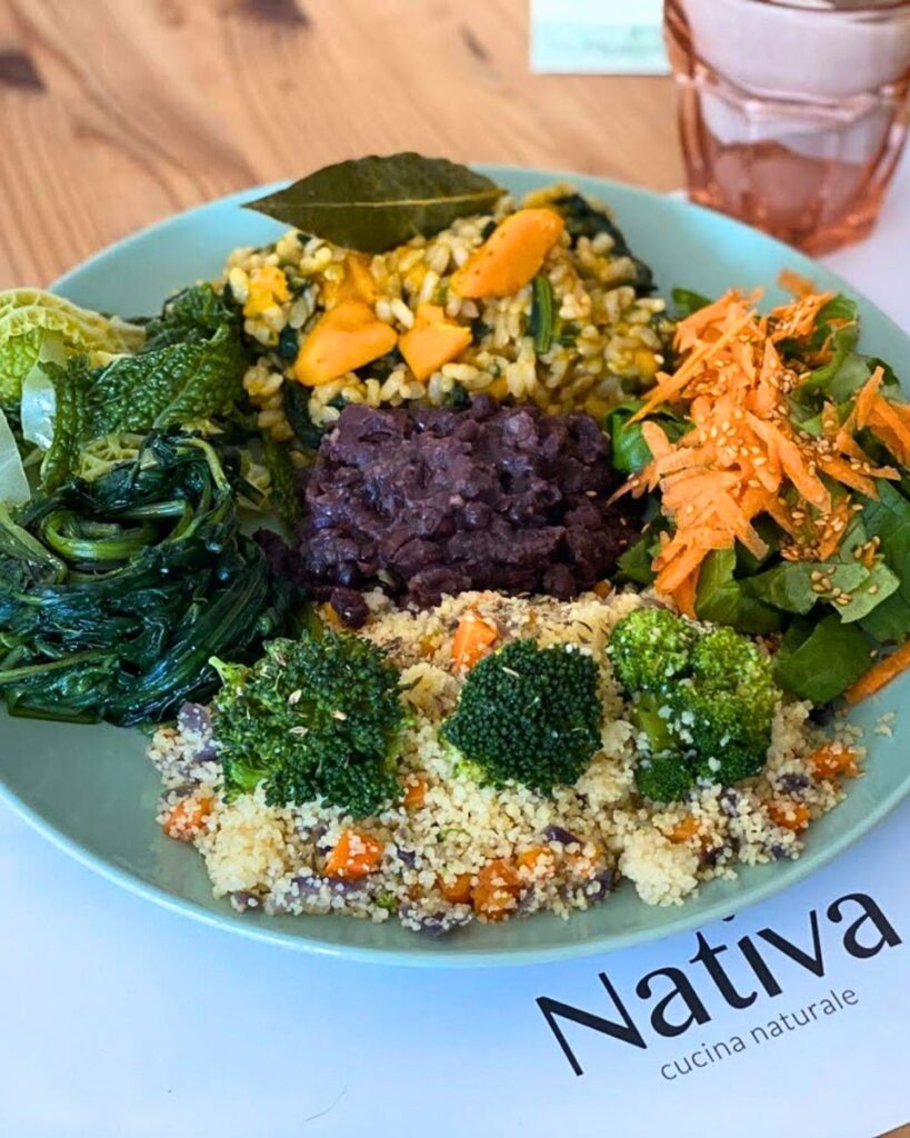  Colorful vegan plate with couscous, beans, greens, and carrots at Nativa Ristorante, a popular vegan restaurant in Rome.