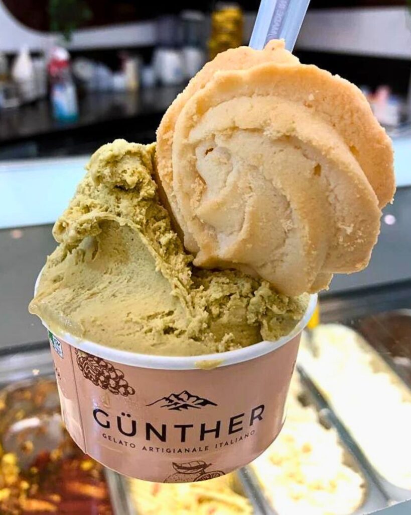 A cup of artisanal gelato from Günther Gelato Italiano in Rome, featuring two scoops of different flavors, showcasing the best ice cream in Rome with a premium gelato aesthetic.