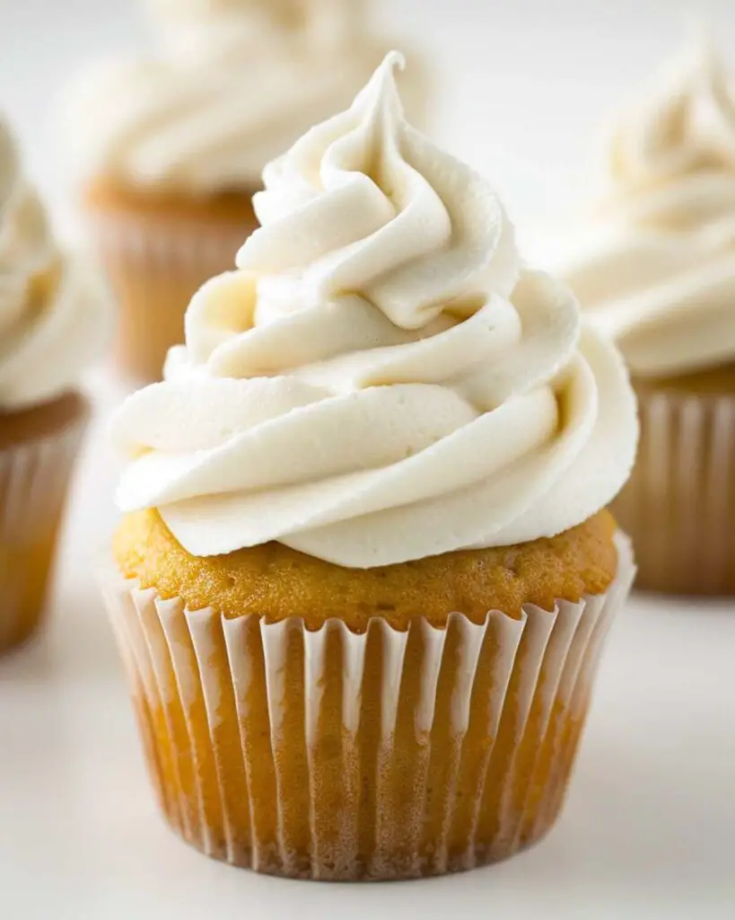 Italian meringue buttercream cupcakes topped with light and airy swirls of frosting, showcasing cupcakes with Italian buttercream, perfect for Italian desserts cupcakes and Italian birthday cupcakes.