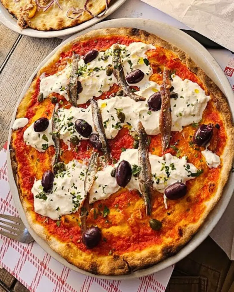 A vibrant display of gourmet pizzas at L'Elementare in Trastevere, showcasing why it’s celebrated as one of Rome’s best pizza places.