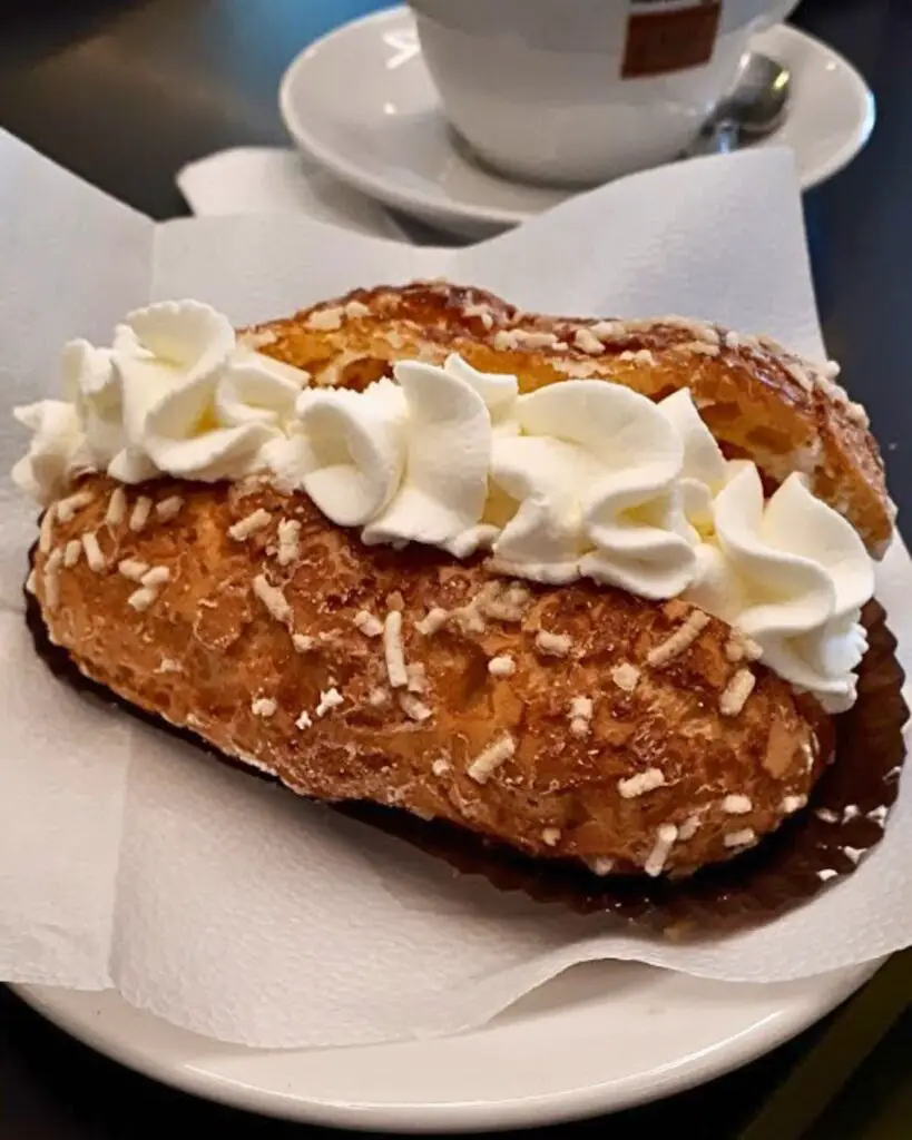 Famous maritozzo from Pasticceria Walter Musco in Rome, topped with fresh whipped cream.