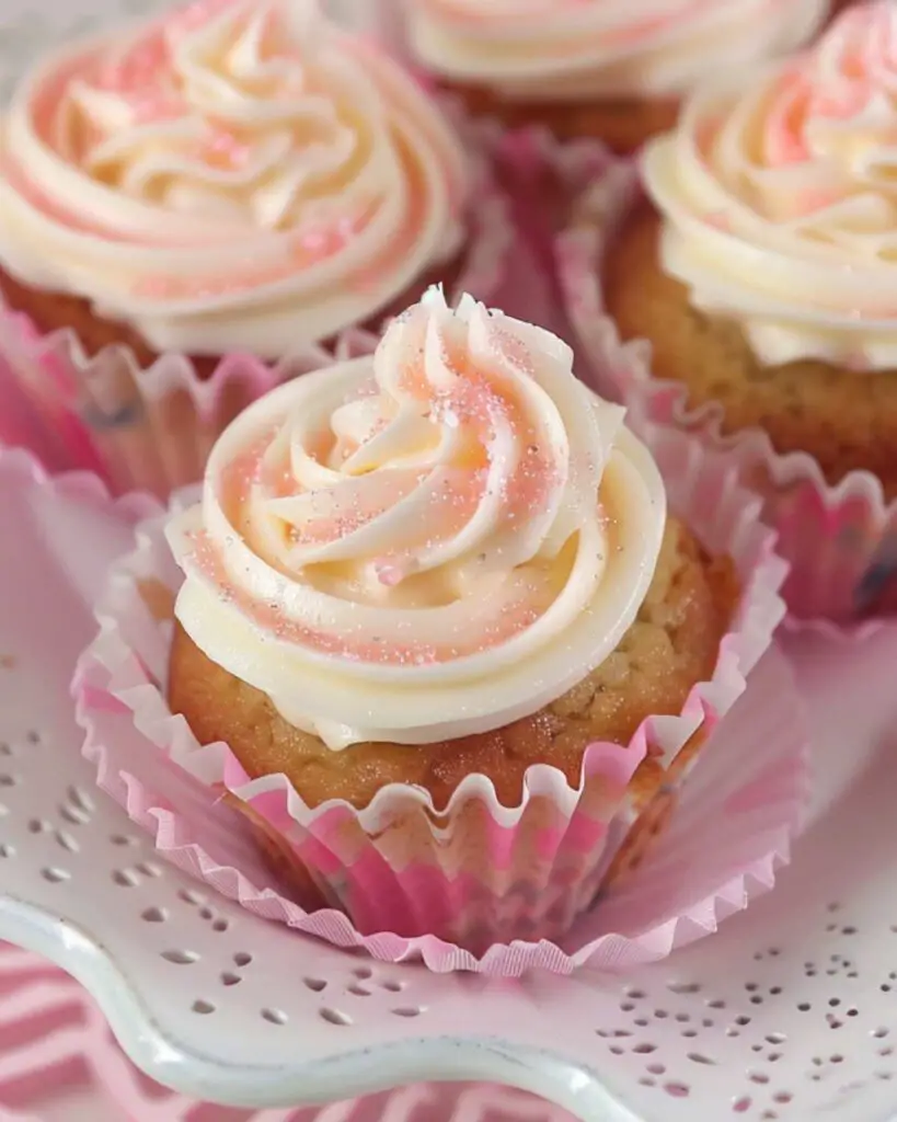 Italian wedding cupcakes topped with cream cheese frosting and pink sprinkles, showcasing Italian themed cupcakes and Italian decorated cupcakes.