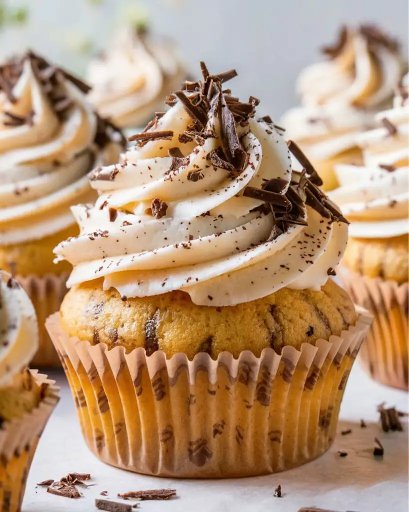 Stracciatella cupcakes topped with fluffy stracciatella buttercream and dark chocolate shavings, showcasing Italian flavored cupcakes and Italian desserts cupcakes.