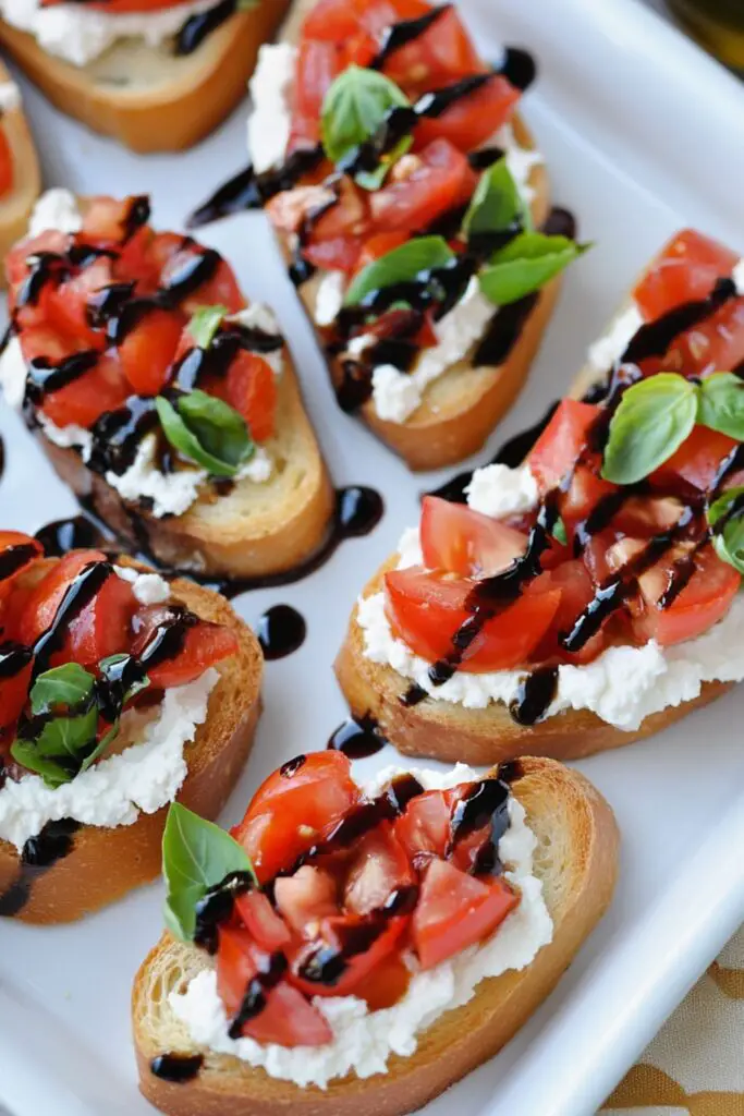 Bruschetta topped with goat cheese, tomatoes, and balsamic glaze