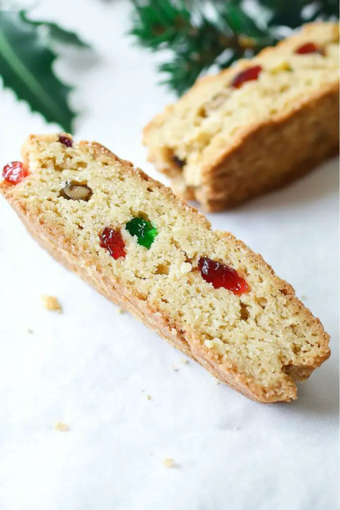 A close-up of fruit and nut Italian Christmas biscotti, featuring a crispy, twice-baked texture with visible pieces of candied fruit and nuts. These biscotti are perfect for dipping into coffee or tea and are a popular choice for those seeking traditional Italian Christmas cookie recipes.