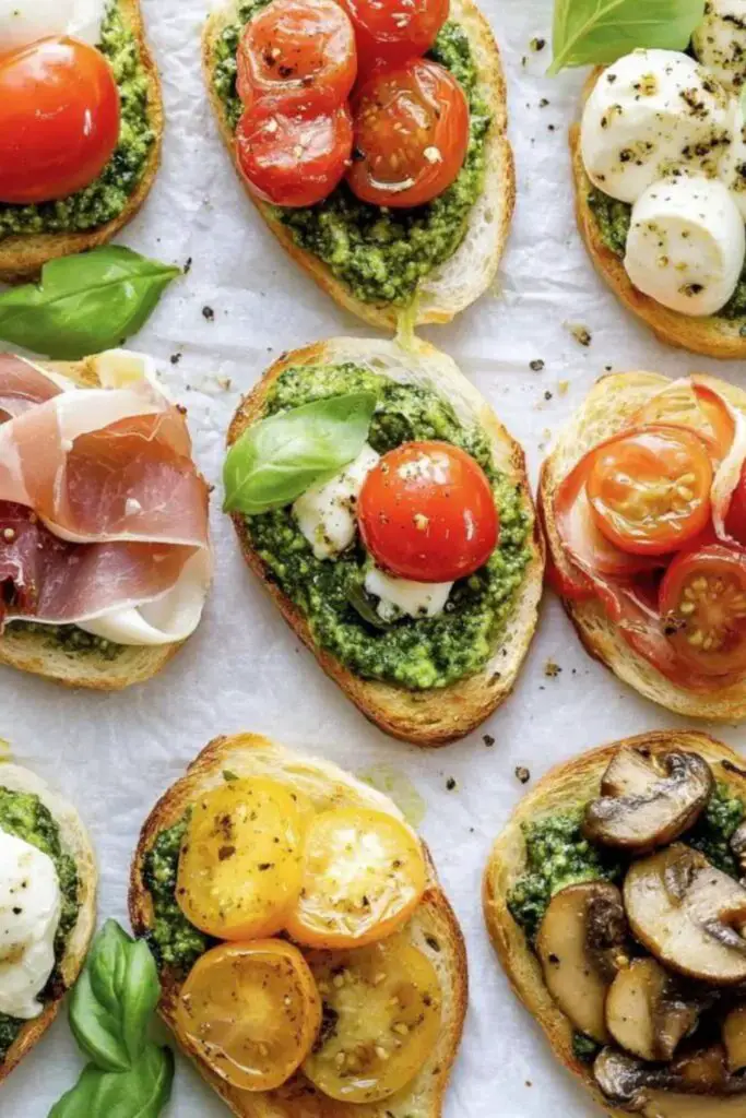 Italian-themed Christmas Pesto Crostini topped with mozzarella, cherry tomatoes, prosciutto, ricotta, grilled mushrooms, and fresh basil, showcasing three delicious variations on crispy toasted bread.