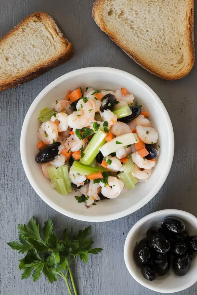 A refreshing Italian seafood salad made with shrimp, calamari, carrots, celery, and black olives, perfect as an Italian Christmas Eve appetizer or antipasto for a festive holiday dinner.