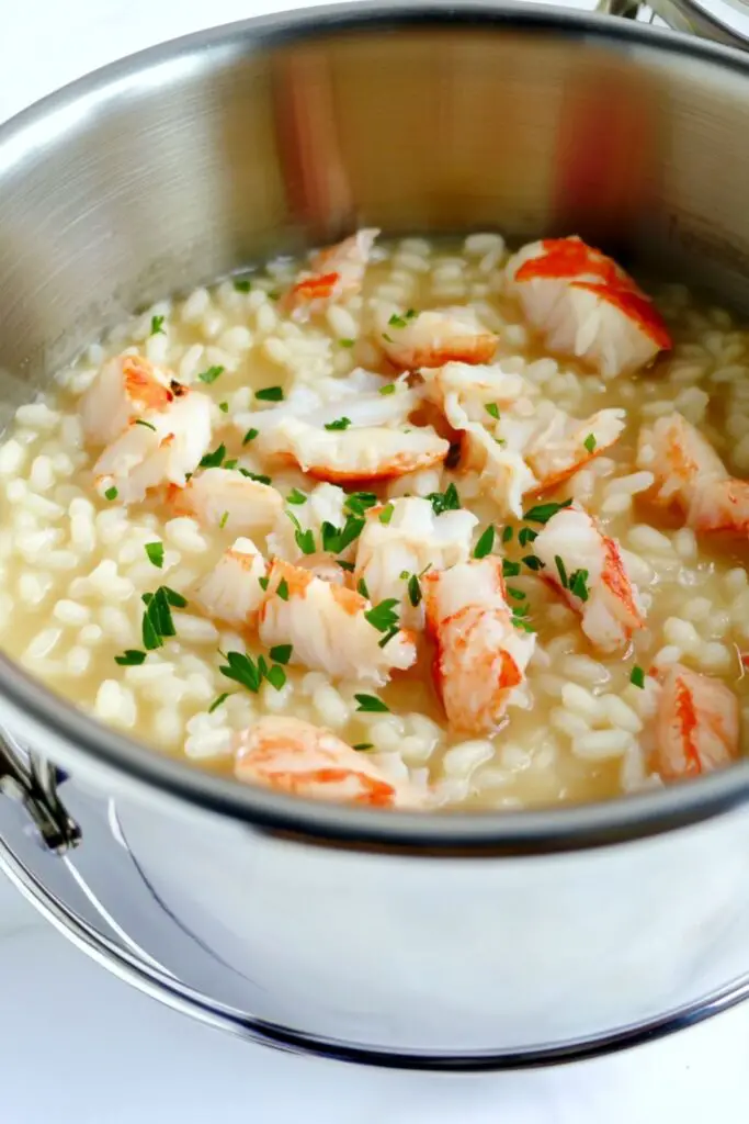 Seafood risotto with lobster, scallops, and shrimp, garnished with fresh herbs, perfect for an Italian Christmas Eve dinner as part of the feast of 7 fishes Italian Christmas tradition.