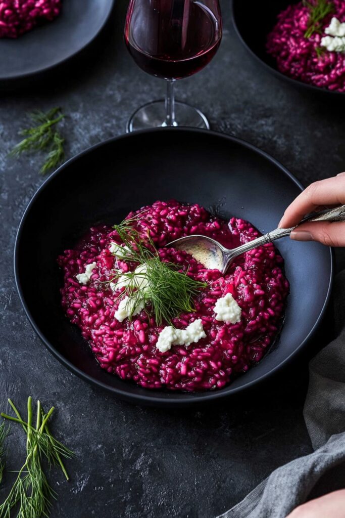 A bowl of beet risotto topped with crumbled goat cheese, a delicious Valentine dinner party or romantic meals choice.