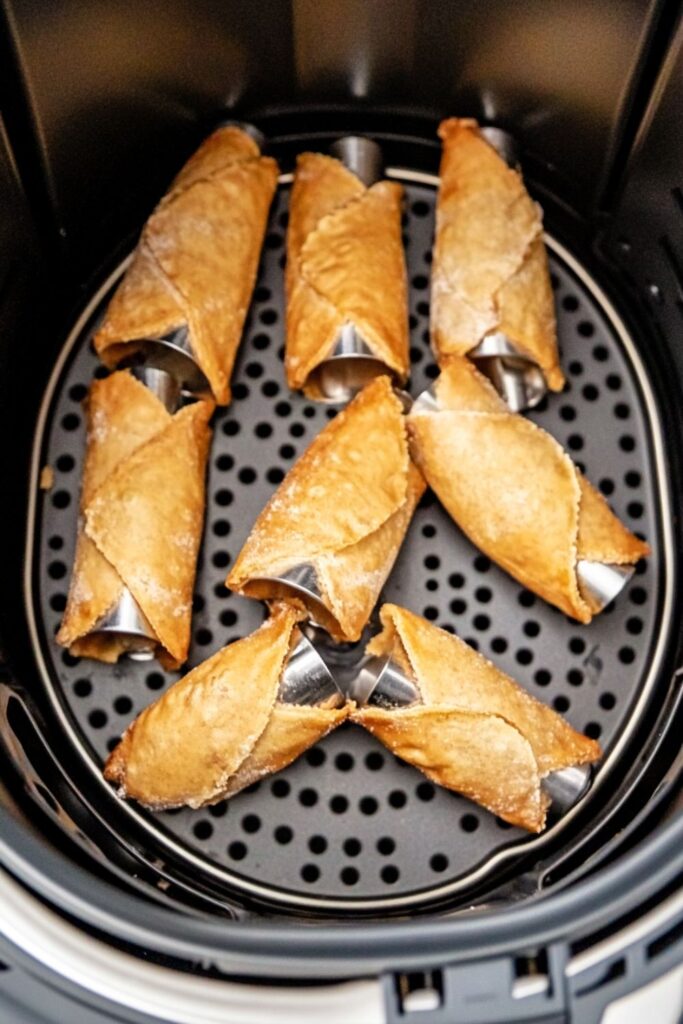 Crispy and golden air fryer cannoli shells ready to be filled with sweet ricotta cream.