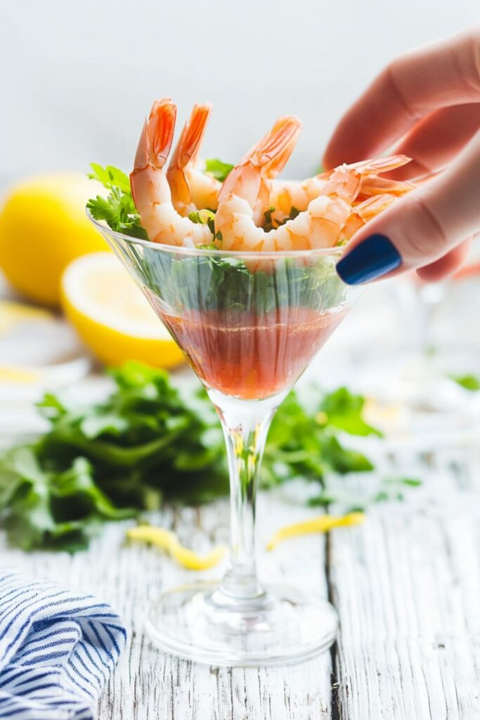 A classic shrimp cocktail served with tangy cocktail sauce, a timeless choice for a Valentines seafood dinner.