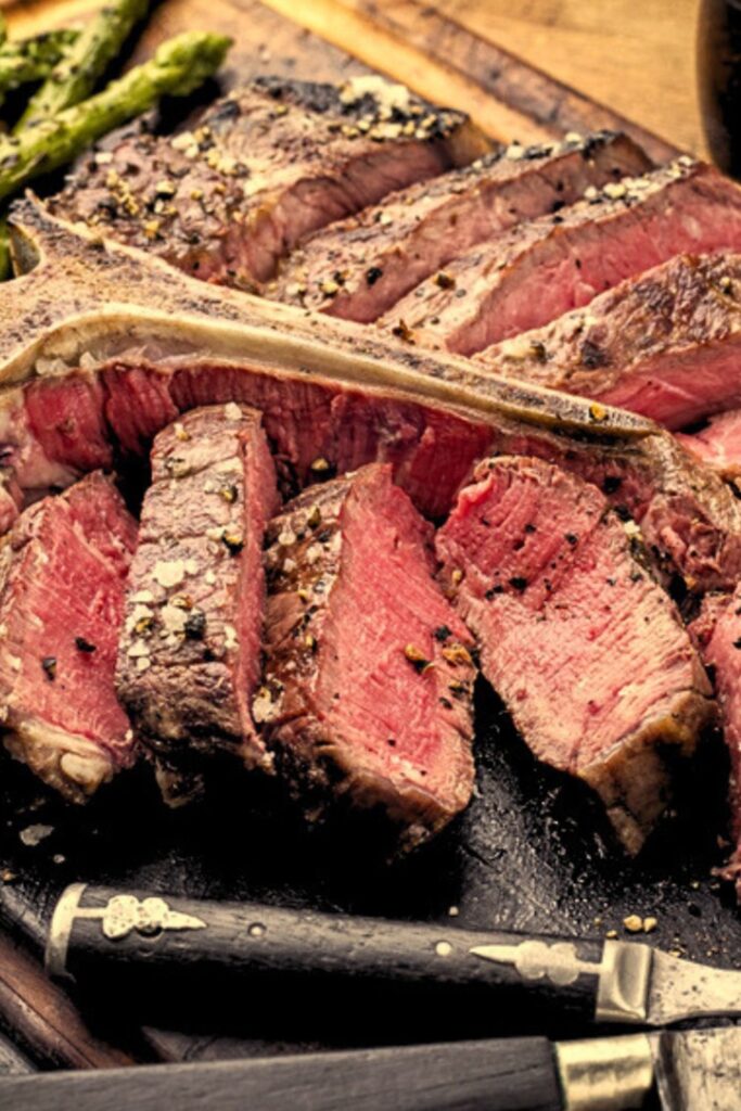 Thick slices of seared porterhouse steak with coarse salt, featured as Italian Easter Side Dishes.