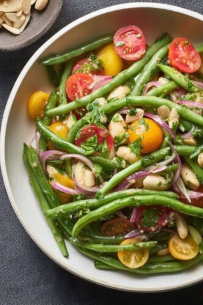 A white bowl filled with a fresh salad of green beans, cherry tomatoes, and cannellini beans for a healthy Easter lunch.