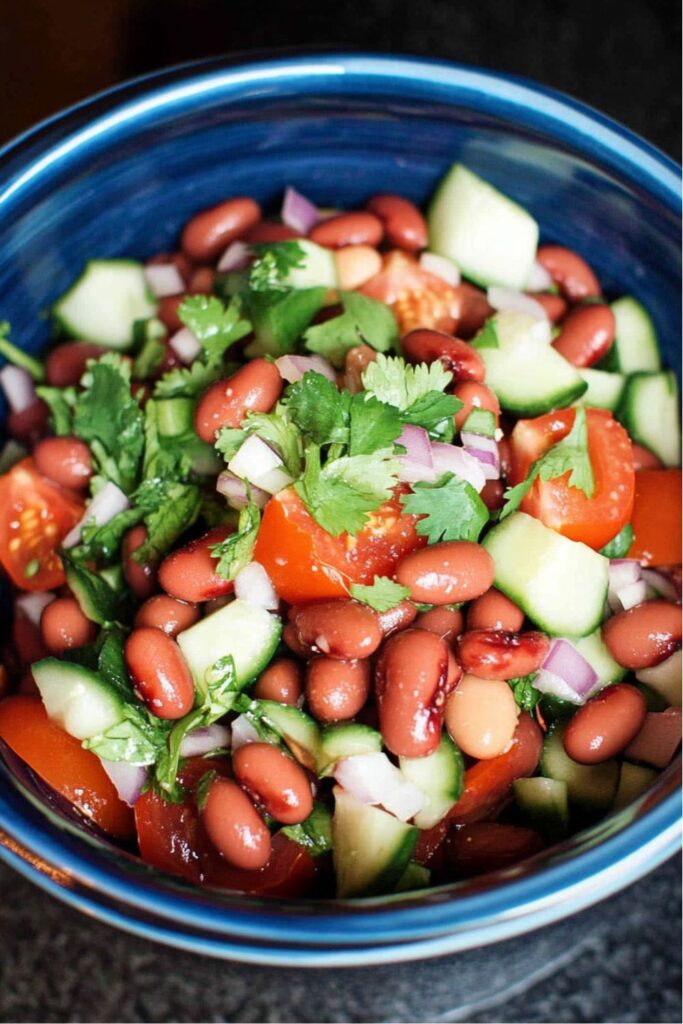A bowl of kidney beans and diced cucumbers, a fresh choice for picnic side dishes.